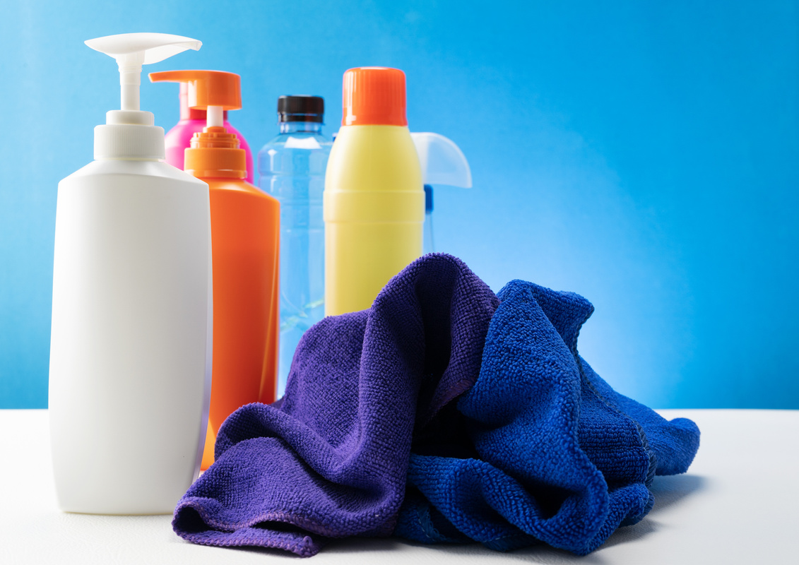 Plastic Bottles of Cleaning Products with Clean Towel